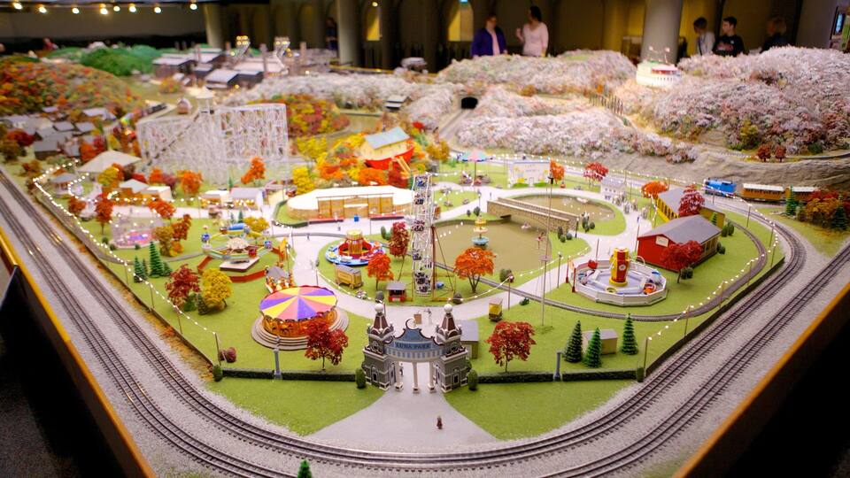 A detailed model train layout with a central station, tracks, and various buildings and structures.