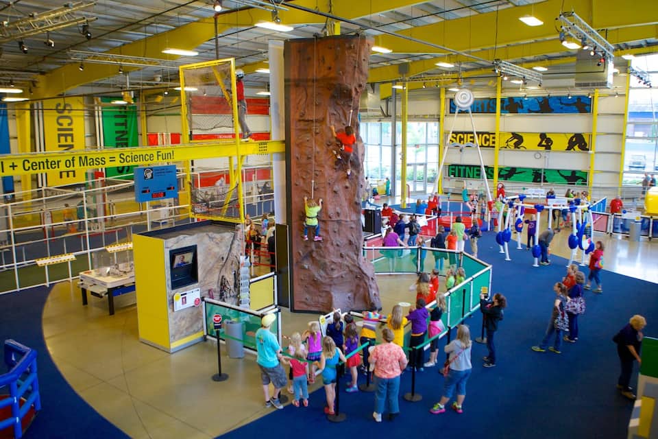 An indoor climbing center with a large rock wall and various climbing equipment.