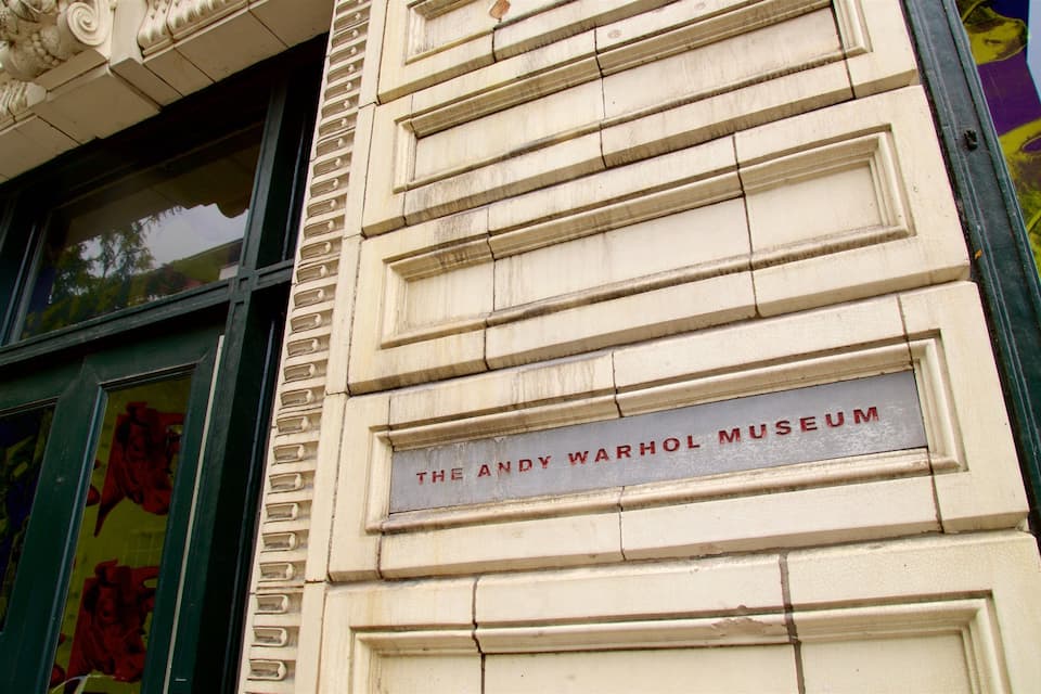 A building facade with a plaque reading "The Andy Warhol Museum".