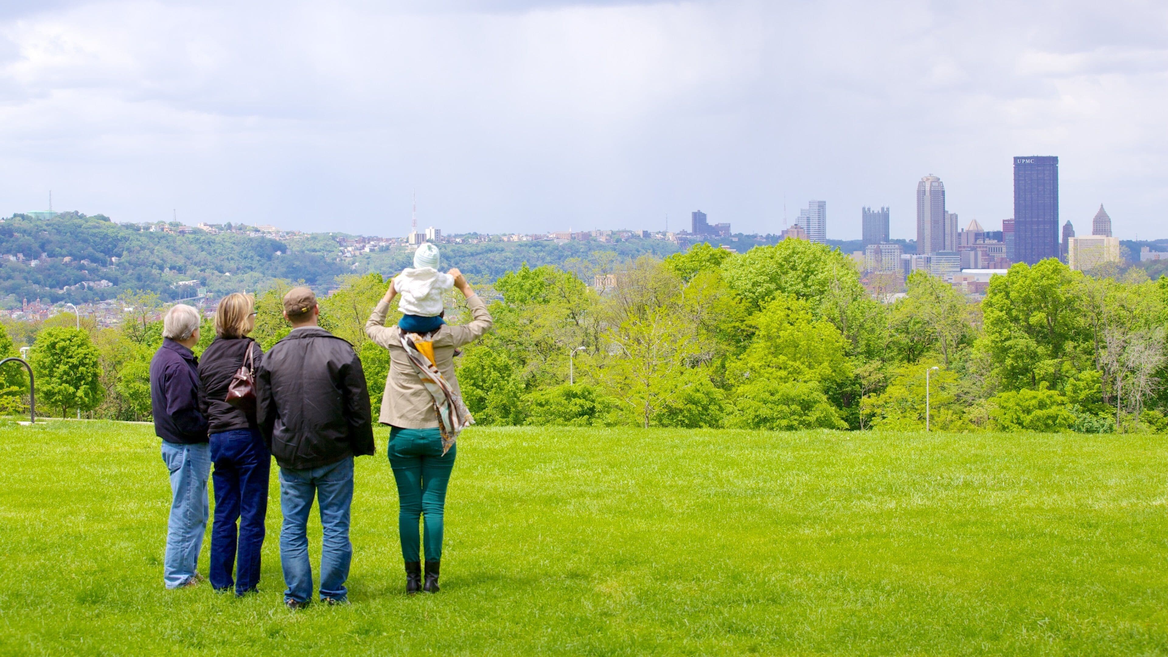 Schenley Park featuring skyline and a garden as well as a small group of people