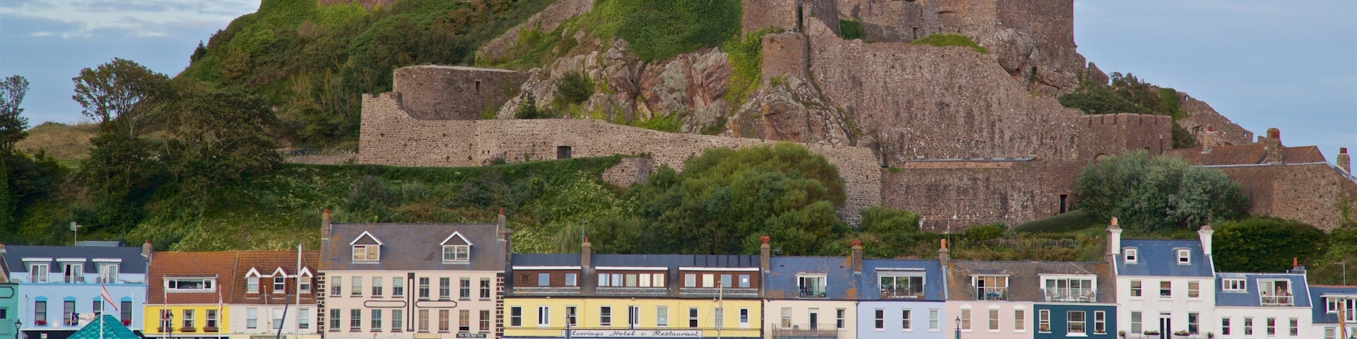 Mont Orgueil Castle showing a castle, a bay or harbor and a coastal town