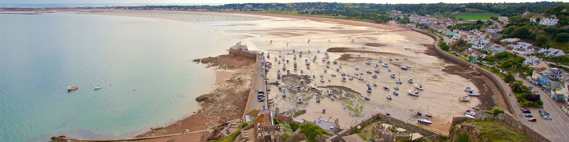 Mont Orgueil Castle which includes a beach, general coastal views and a ruin