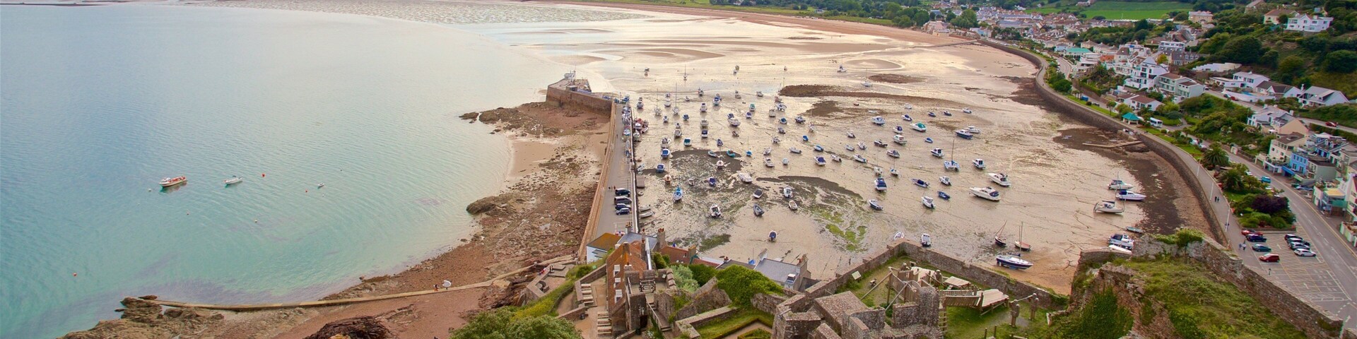 Mont Orgueil Castle which includes a beach, general coastal views and a ruin