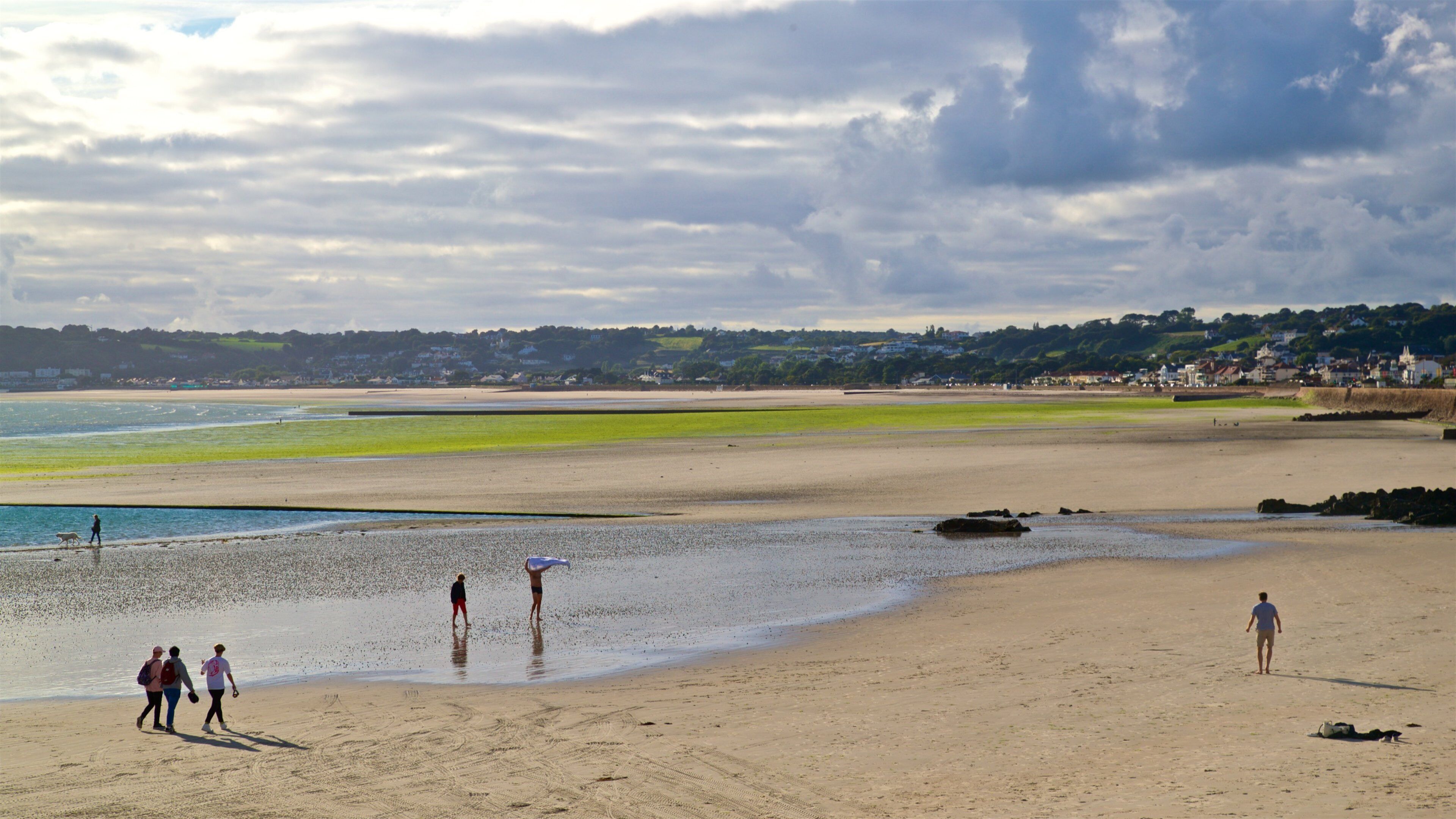 St. Helier Beach which includes a sandy beach and general coastal views as well as a small group of people