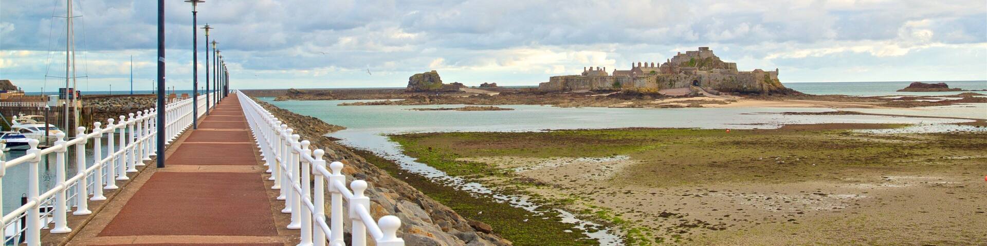 St. Helier Beach showing chateau or palace and general coastal views