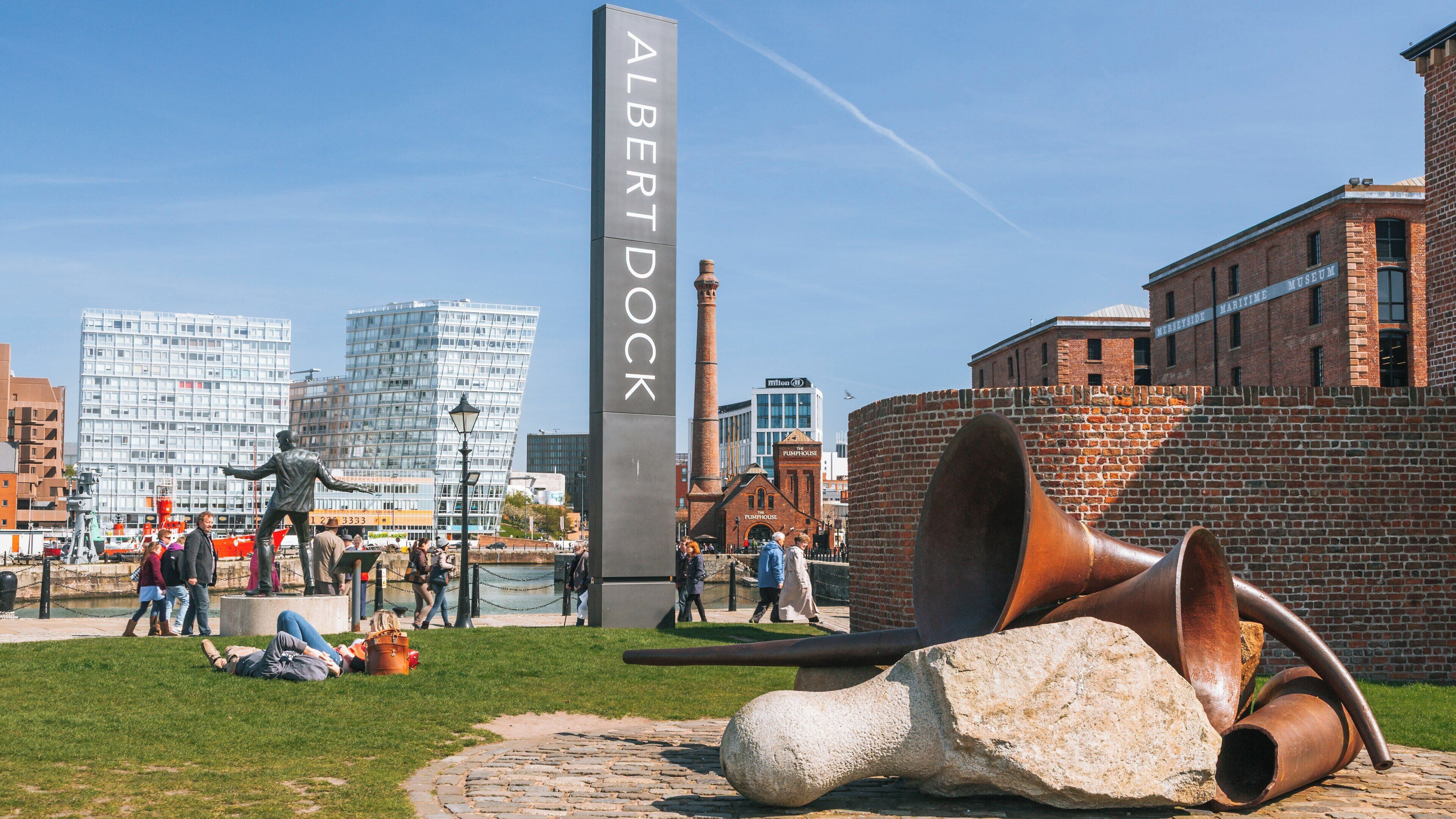 Exploring Royal Albert Dock in Liverpool City Centre with visitors enjoying the vibrant atmosphere and historical architecture