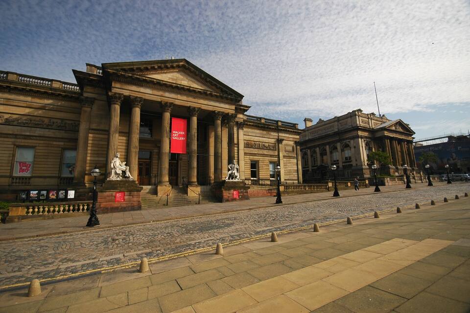 A classical building with columns and a red banner.