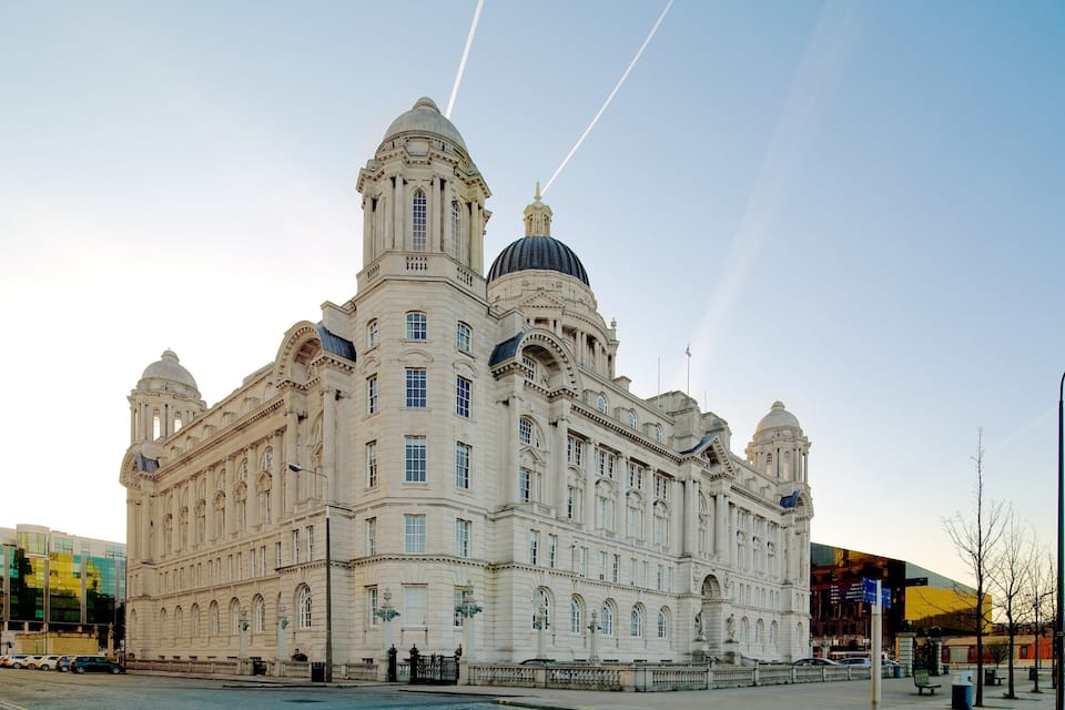 A large, ornate building with multiple domes and columns.