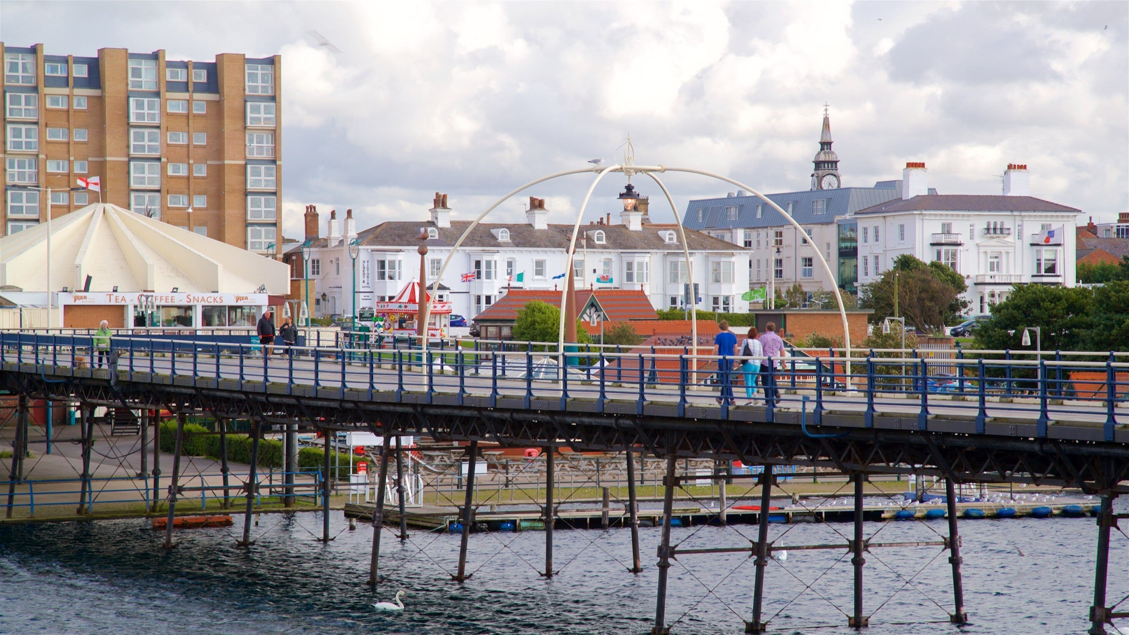 Southport Pier which includes a bridge and a river or creek as well as a small group of people