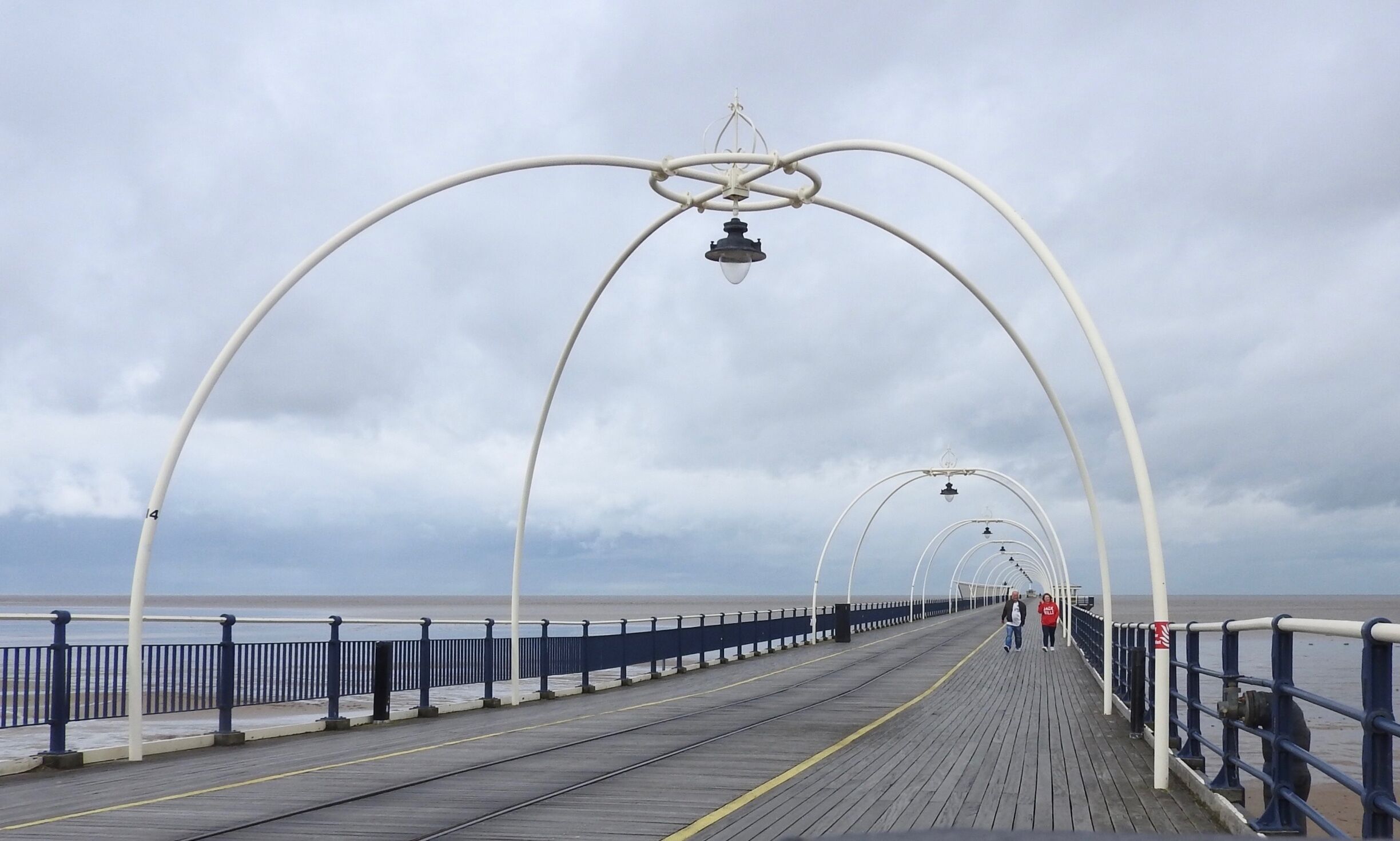 Southport Pier, first opened in August 1860, is the oldest iron pier in the country and spans a length of 1,108 metres (3,635 ft), making it the second-longest in Great Britain. Although at one stage reaching out 4,380 feet (1,340 m), a succession of storms and fires during the late 19th and early 20th century have reduced its length to that of the present day.
