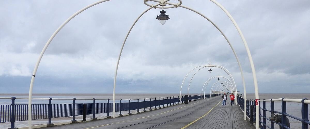 Southport Pier, first opened in August 1860, is the oldest iron pier in the country and spans a length of 1,108 metres (3,635 ft), making it the second-longest in Great Britain. Although at one stage reaching out 4,380 feet (1,340 m), a succession of storms and fires during the late 19th and early 20th century have reduced its length to that of the present day.