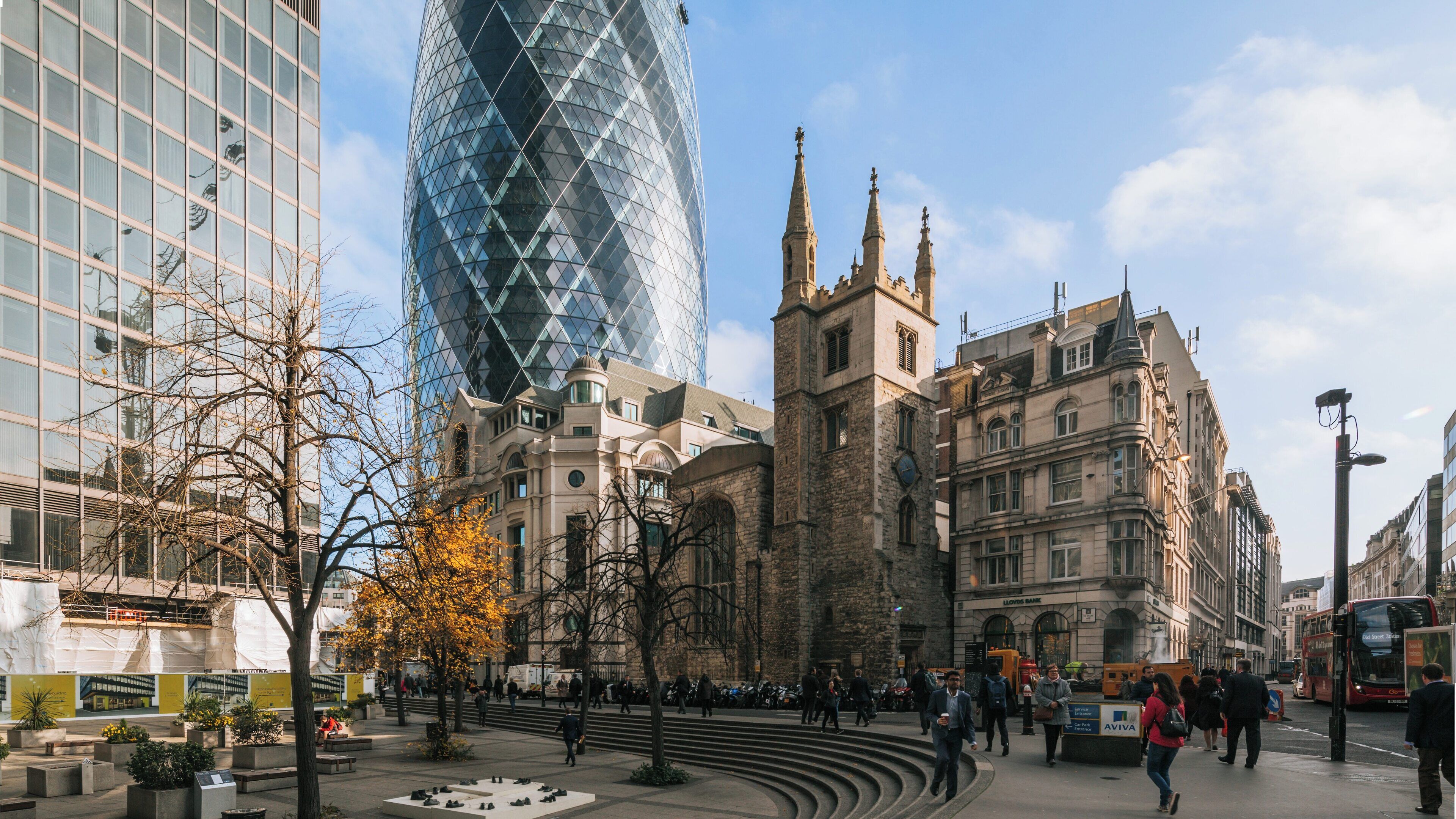 Modern architecture meets history in London City Centre by The Gherkin while people enjoy the vibrant urban atmosphere