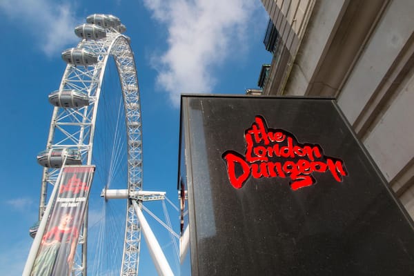The London Dungeon sign and a Ferris wheel.