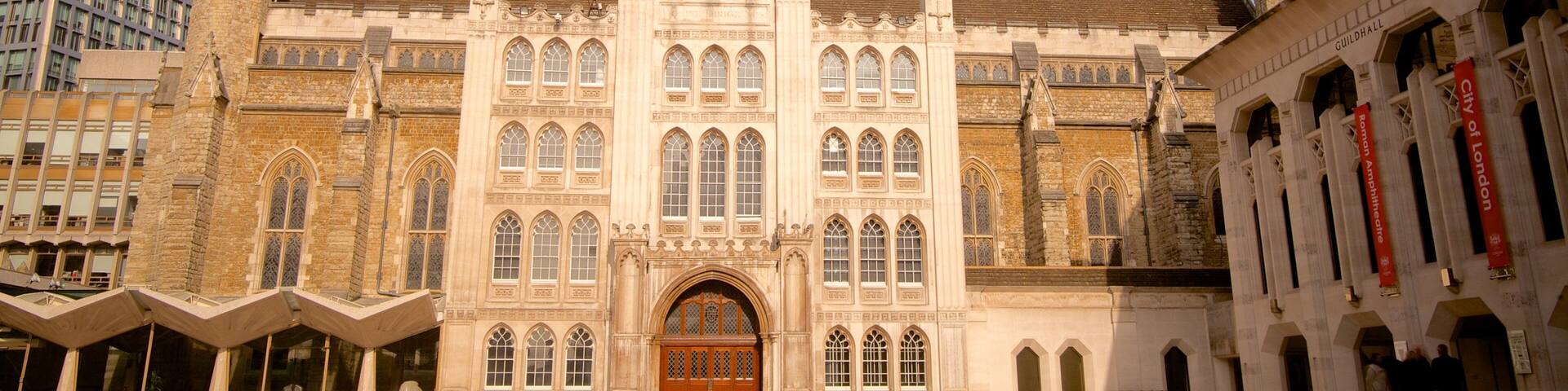 A historic building with a large central tower, arched windows, and a prominent entrance.