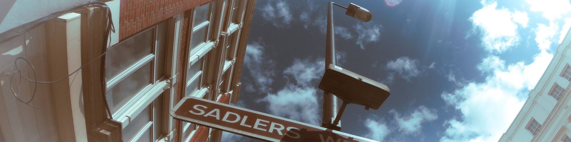 Low angle shot of the Sadlers Wells Theatre sign captured on a sunny day in London, UK