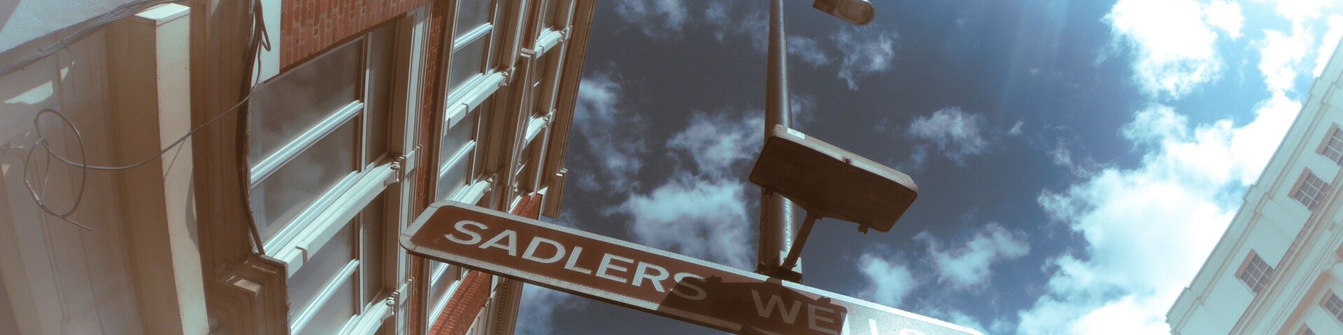 Low angle shot of the Sadlers Wells Theatre sign captured on a sunny day in London, UK