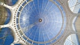 A large, circular glass dome with intricate metal framework.