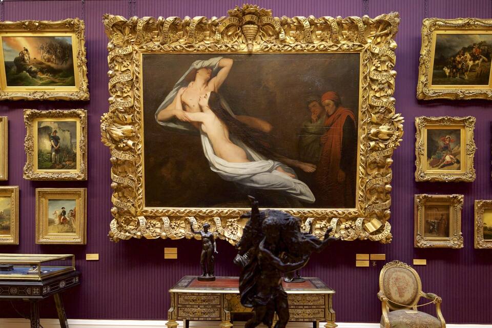 A gallery with a large painting of a woman in a white dress, surrounded by ornate golden frames and classical sculptures.