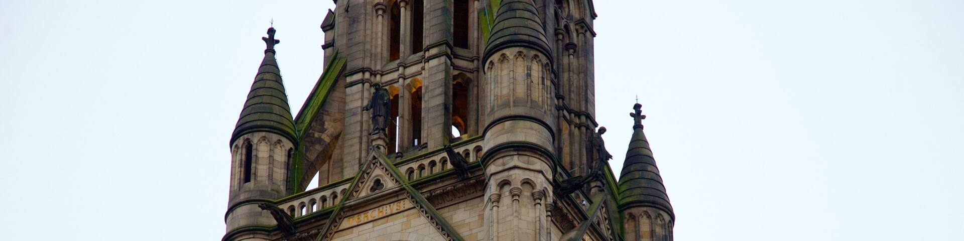 A historic clock tower with intricate architectural details and a large clock face.