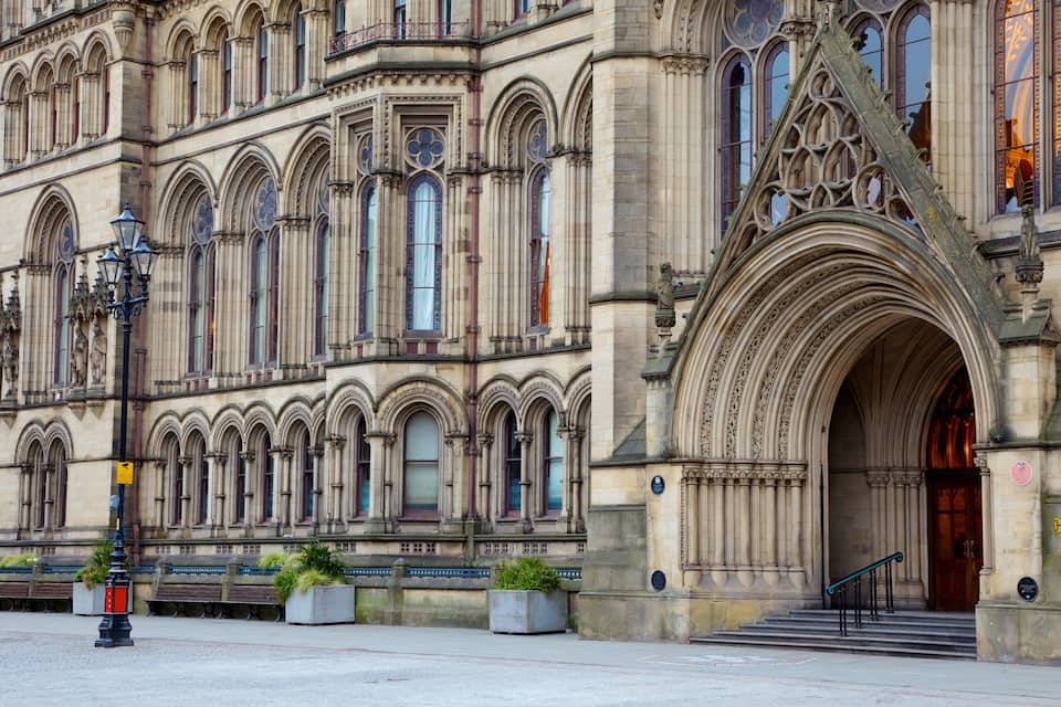 A historic building with ornate Gothic architecture, featuring pointed arches and detailed stonework.