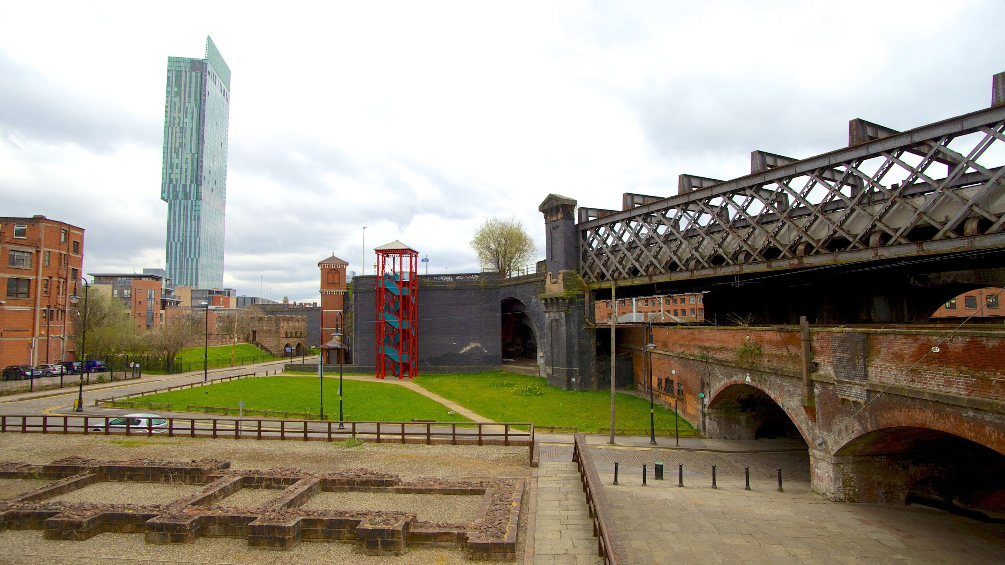 Castlefield Roman Fort featuring a high rise building, building ruins and heritage architecture