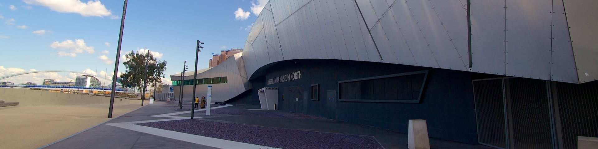 A modern building with a curved facade and a sign reading "Military War Museum North".