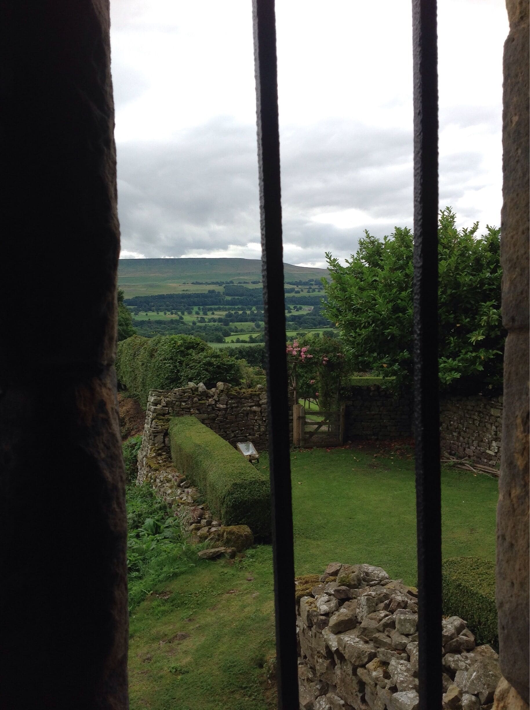 View of the Yorkshire gardens and countryside through the window at Bolton Castle