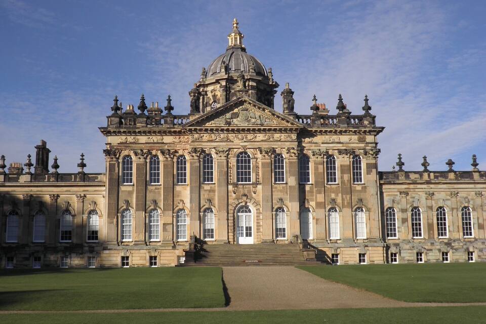 A grand historic building with a large dome and symmetrical facade.