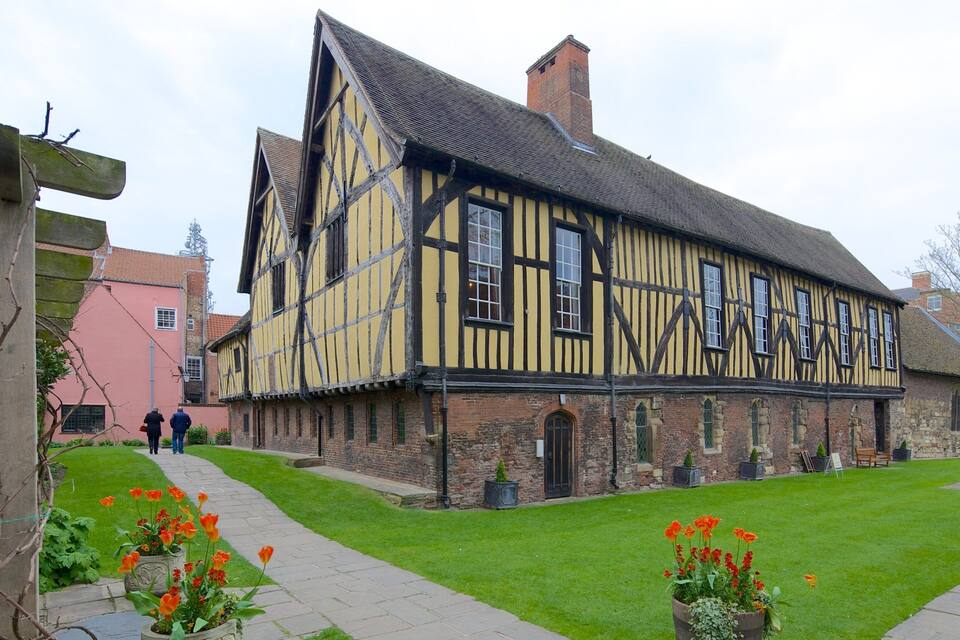 A Tudor-style building with a steeply pitched roof and exposed timber framing.