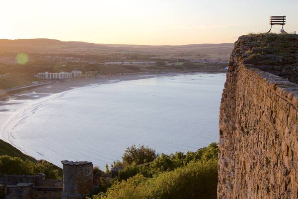 Scarborough Castle which includes a sunset, views and a sandy beach
