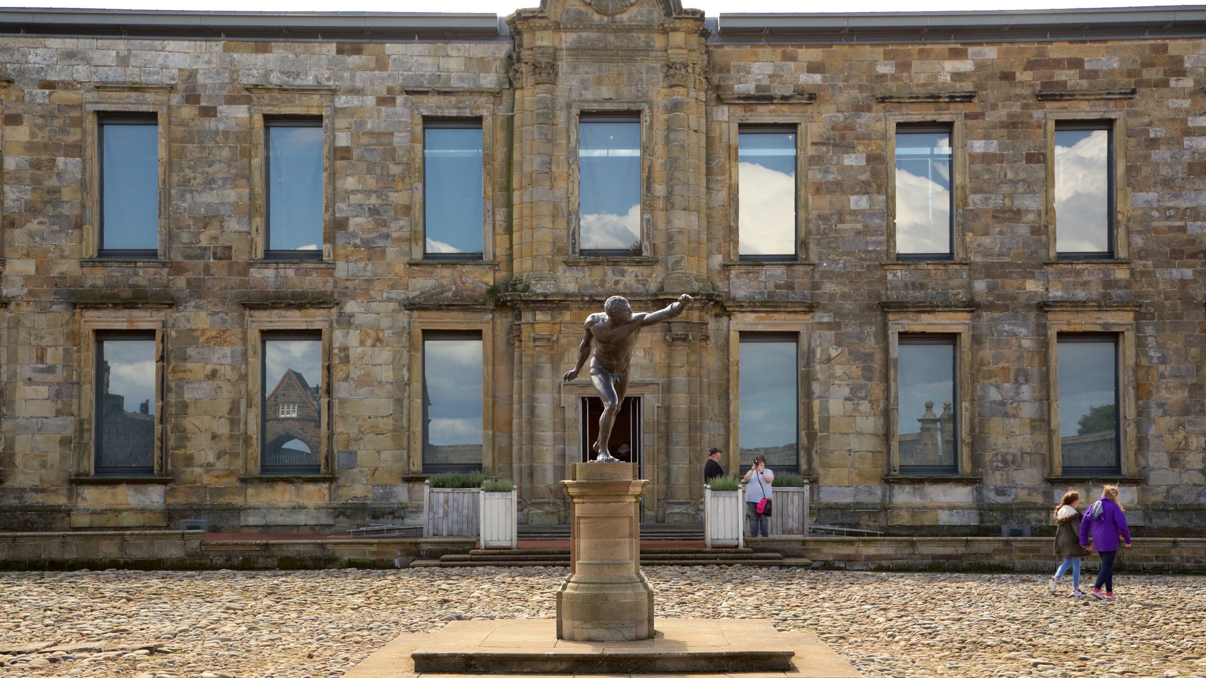 Whitby Abbey featuring a statue or sculpture and heritage elements