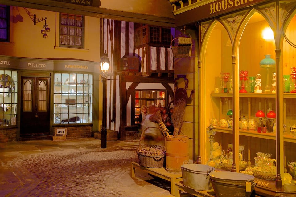 A historic street with shops, including 'H. Hardcastle Pawnbrokers' and 'House of China'.