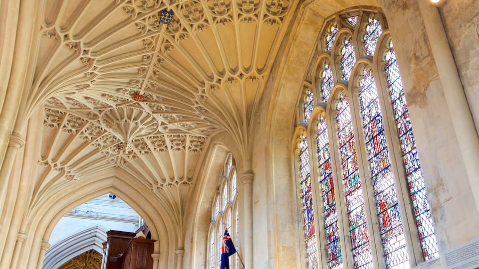 A cathedral interior with intricate ribbed vaults and stained glass windows.