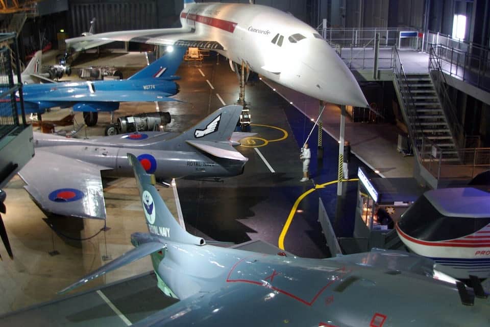 A museum with various aircraft on display, including a Royal Navy plane and a Concorde.