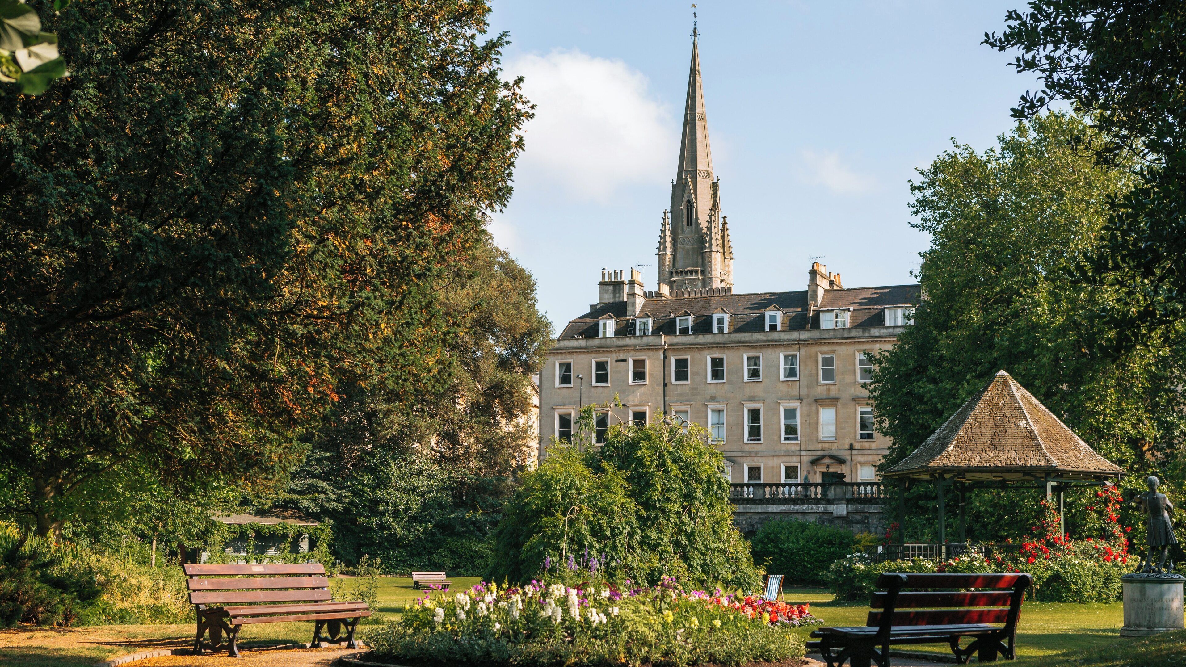 Explore beautiful Parade Gardens in Bath city centre with lush greenery and historic architecture on a sunny day