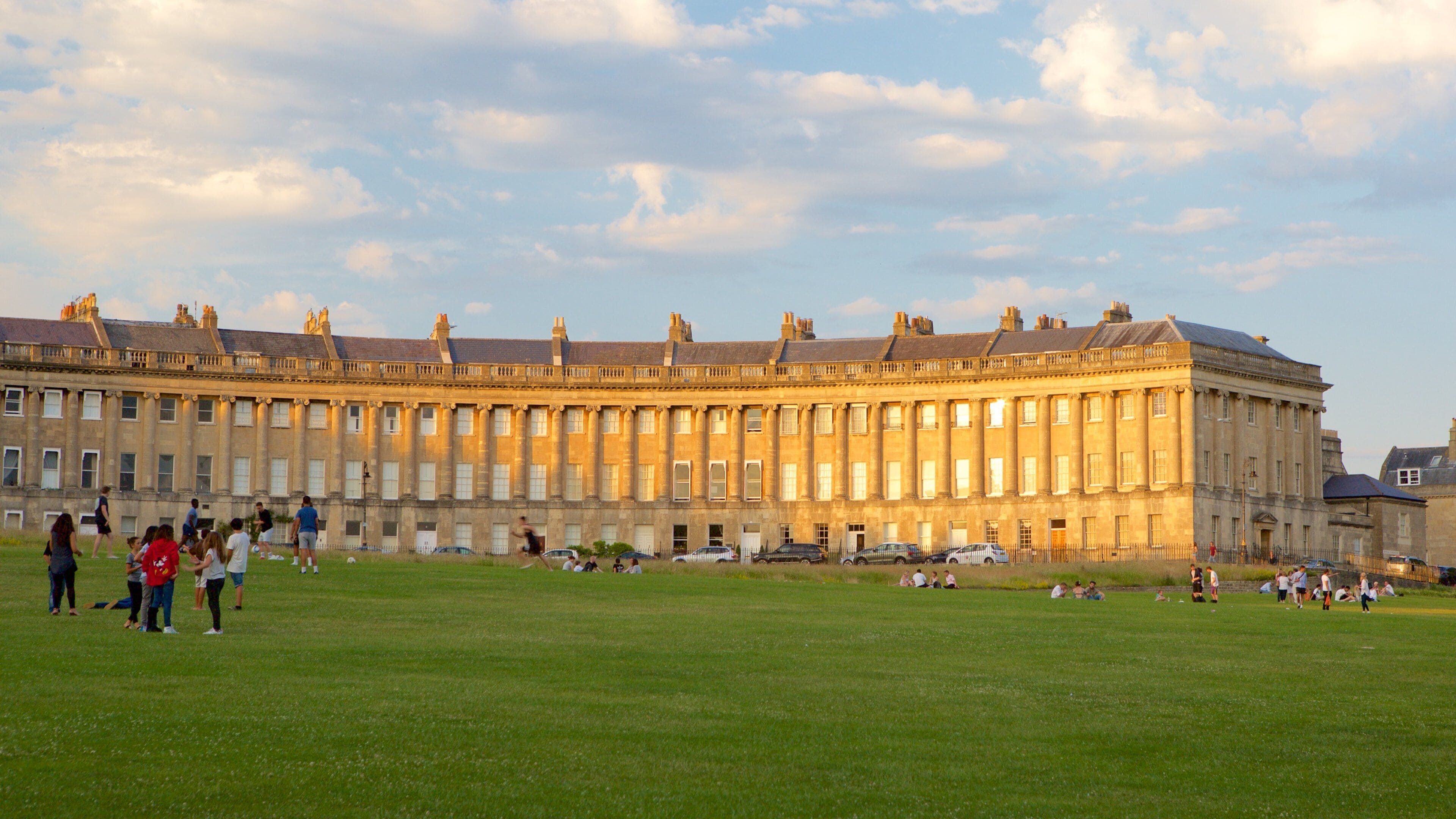 Royal Crescent featuring heritage architecture, a park and an administrative building