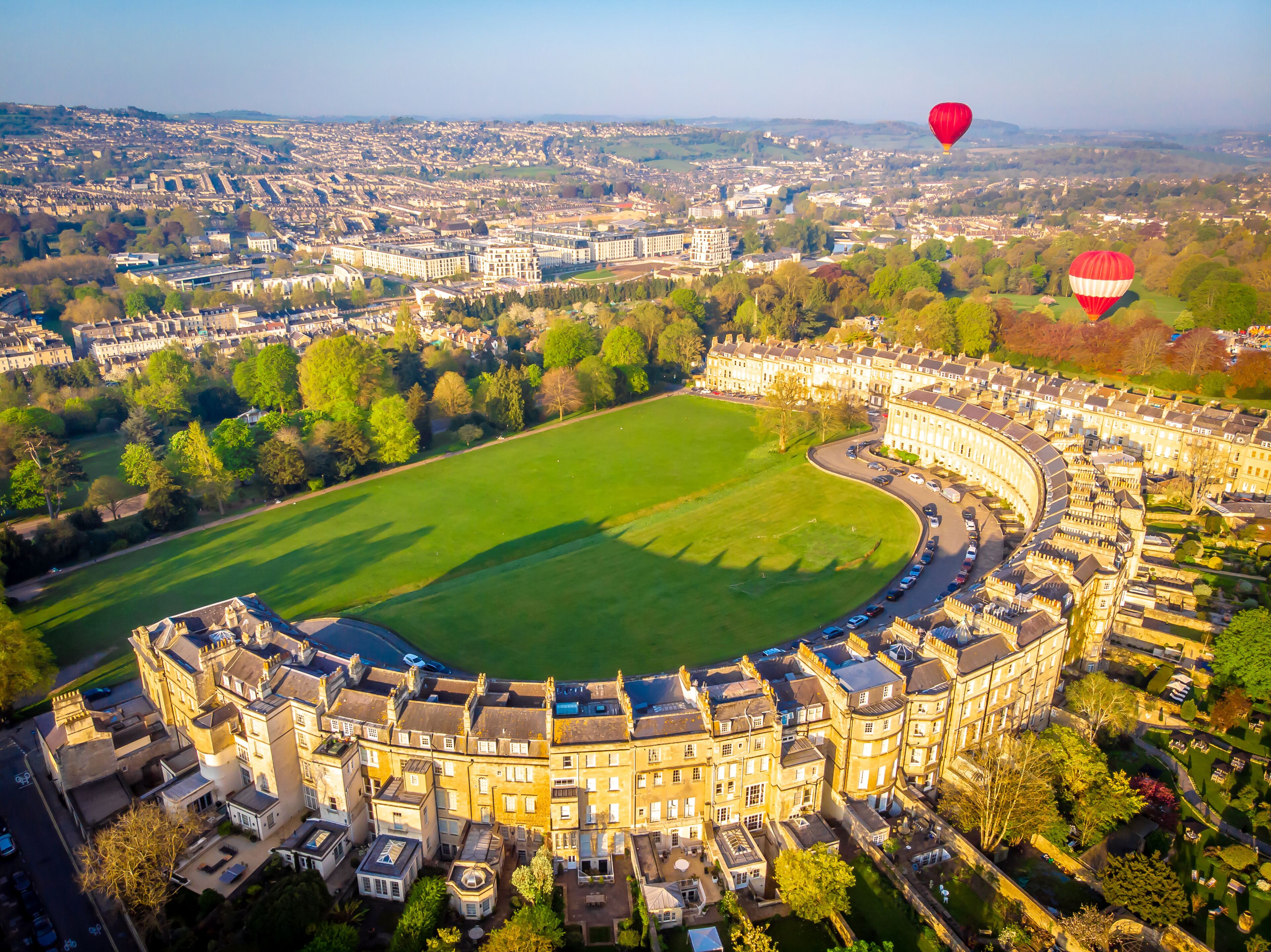 An aerial view of a large stadium surrounded by historic buildings and a cityscape.