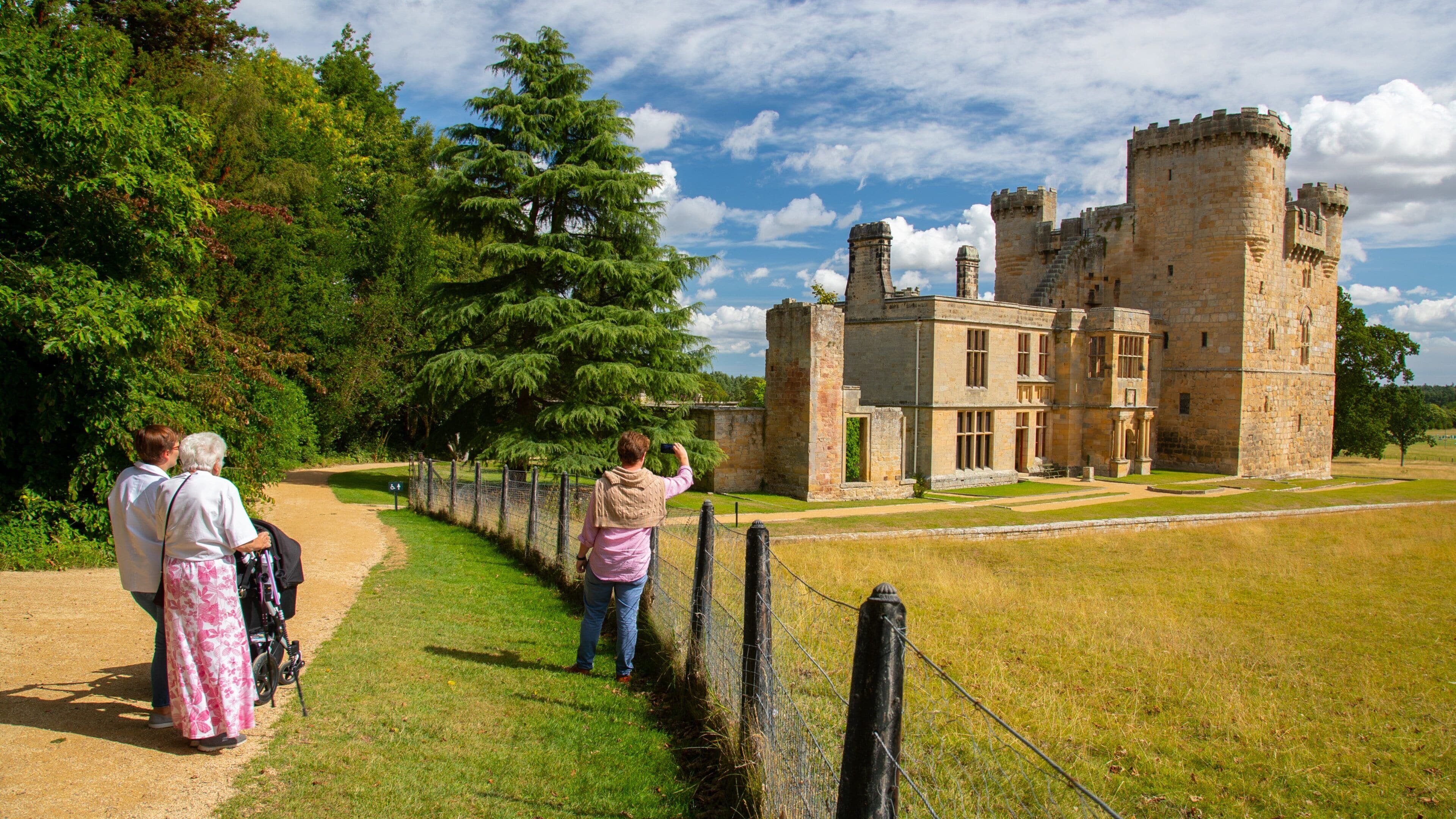 Belsay Hall, Castle and Gardens which includes heritage architecture and a castle as well as a small group of people