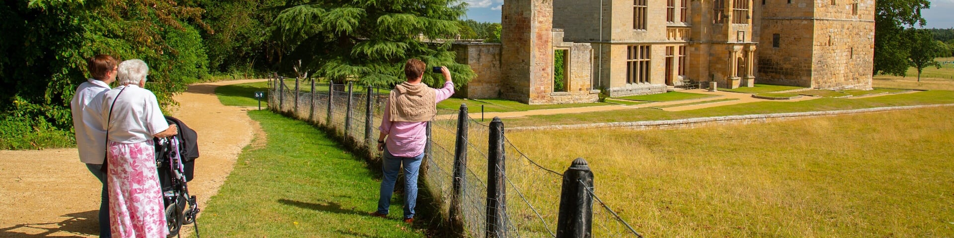 Belsay Hall, Castle and Gardens which includes heritage architecture and a castle as well as a small group of people