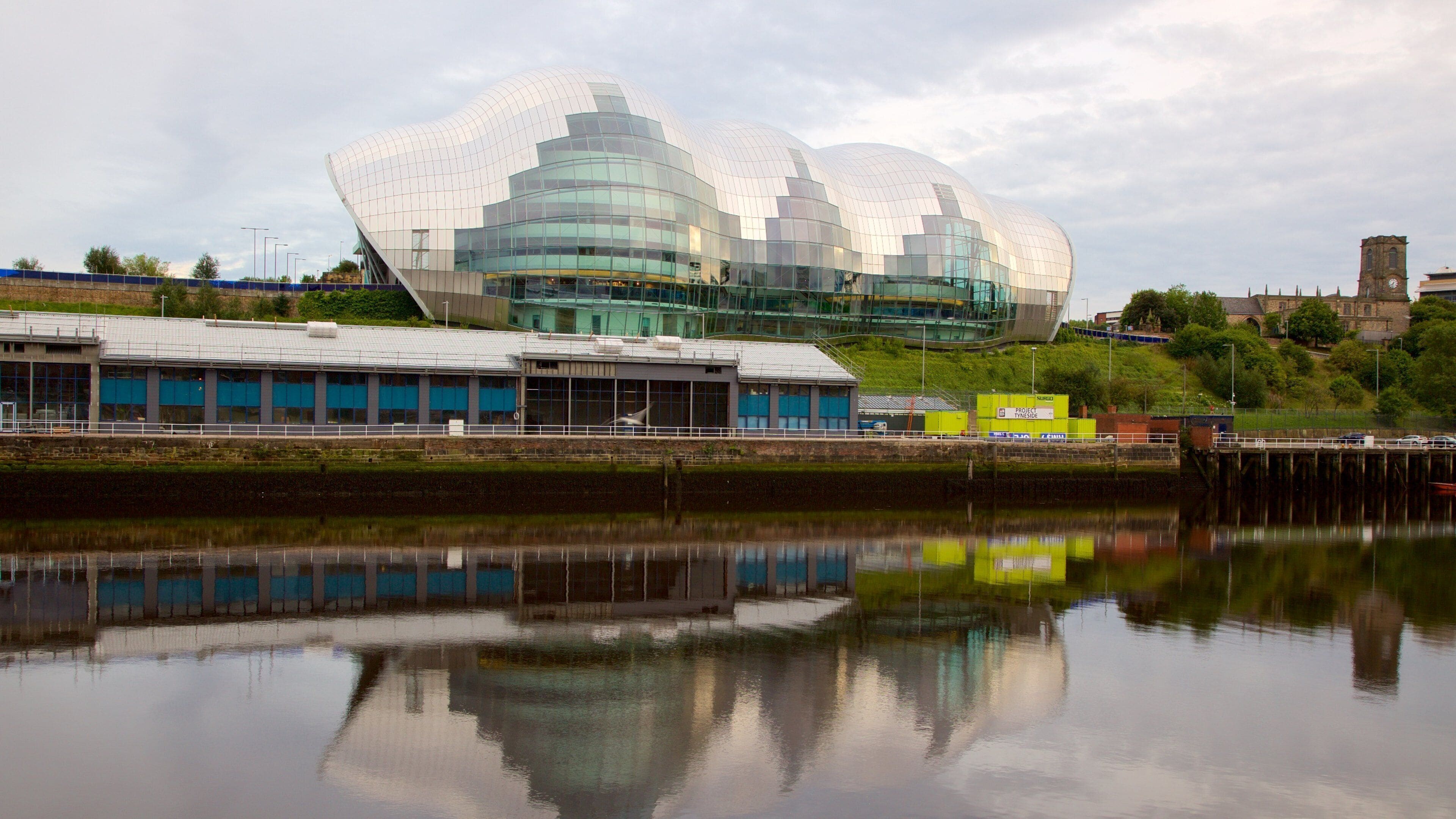Sage Gateshead which includes modern architecture, a river or creek and theatre scenes