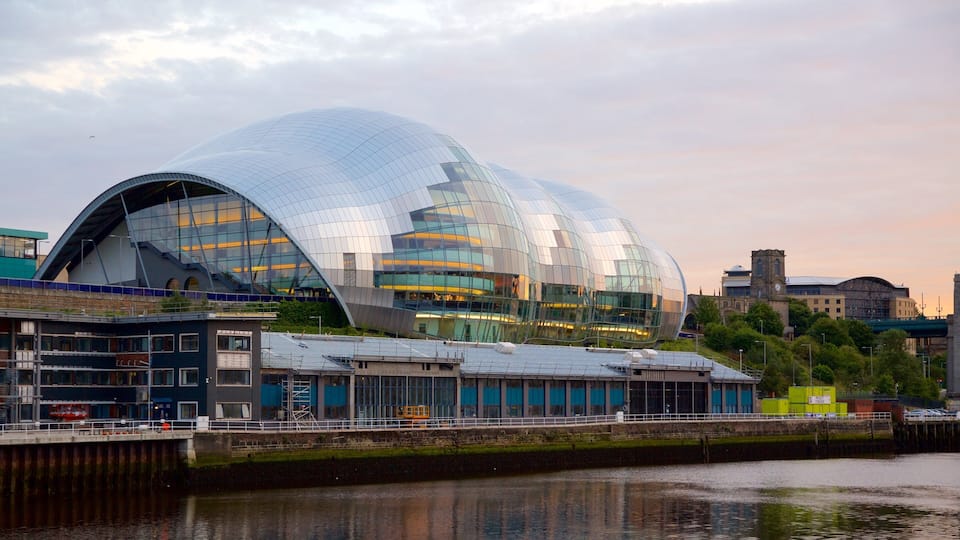 A modern glass dome building with a waterfront view.