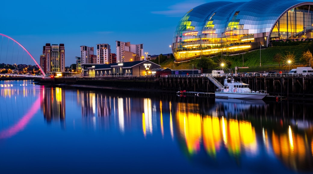 Famous Millennium bridge at night. Illuminated landmarks with river Tyne in Newcastle, UK