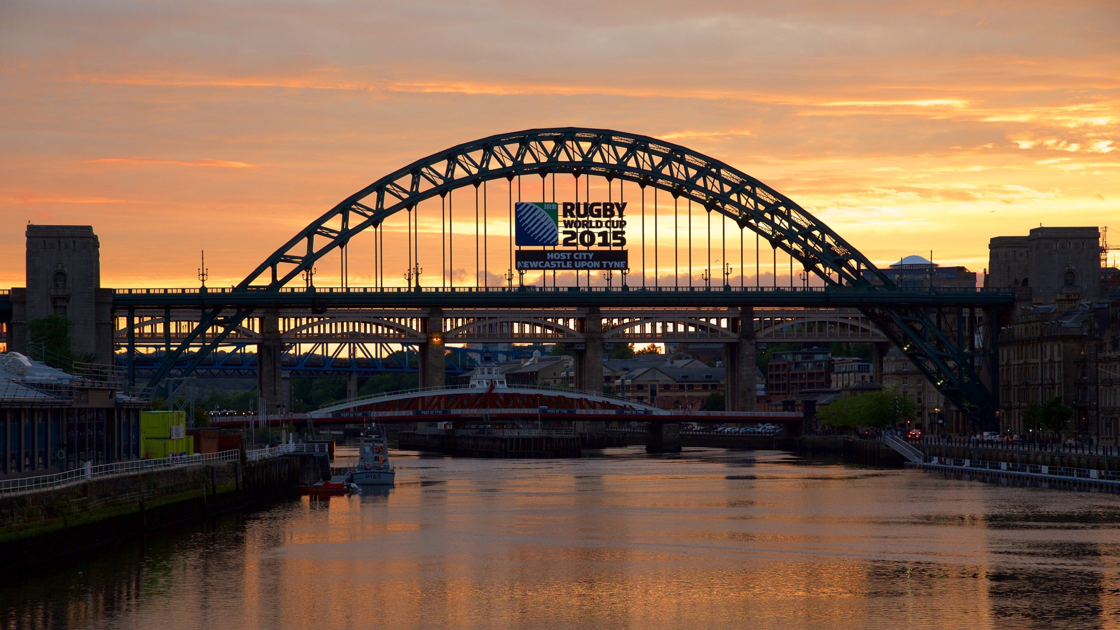 Tyne Bridge showing a city, a river or creek and signage