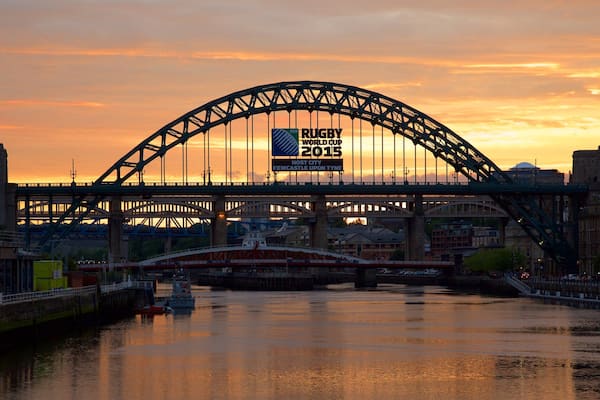 Tyne Bridge showing a city, a river or creek and signage