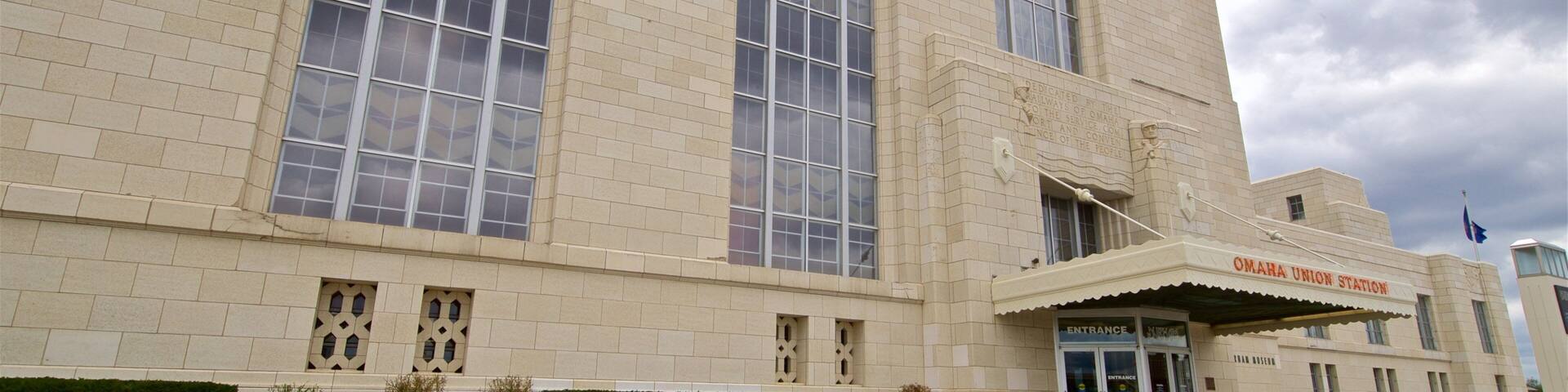 A large beige building with multiple windows and a sign reading "OMAHA UNION STATION".