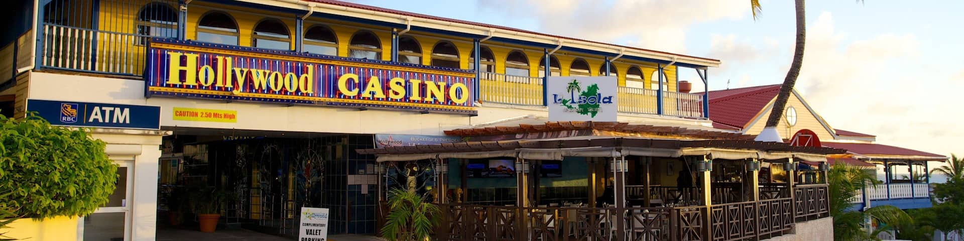 A Hollywood Casino building with a red roof, yellow walls, and a signboard.