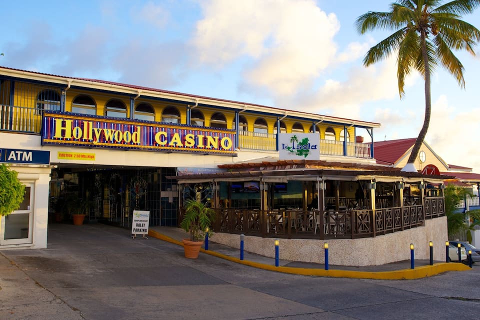 A Hollywood Casino building with a red roof, yellow walls, and a signboard.