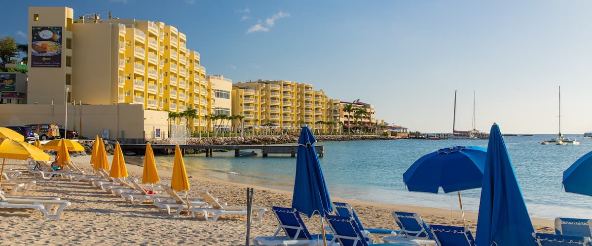 Kim Sha Beach showing a sandy beach, a coastal town and a sunset