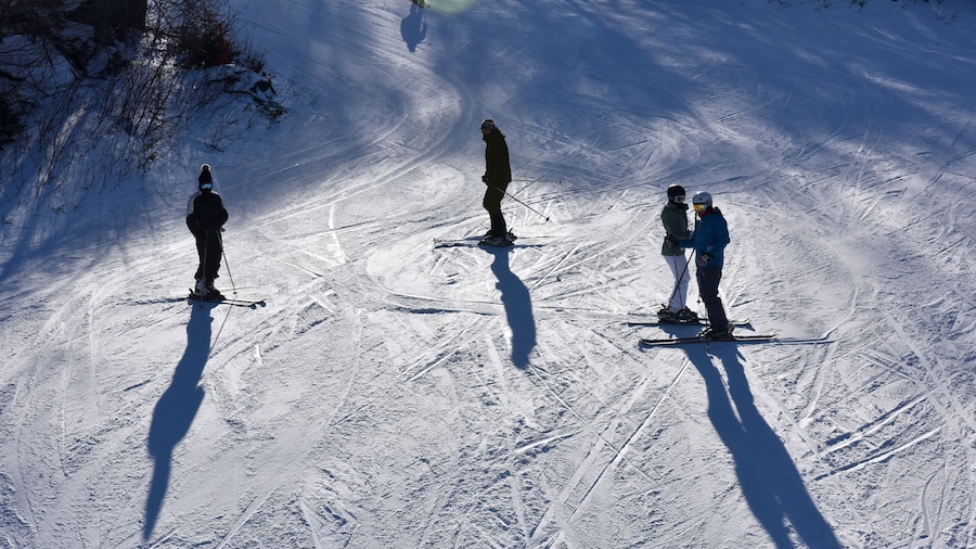 Unidentified skiers standing on the slopes at the Loon Mountain in New Hampshire, USA..