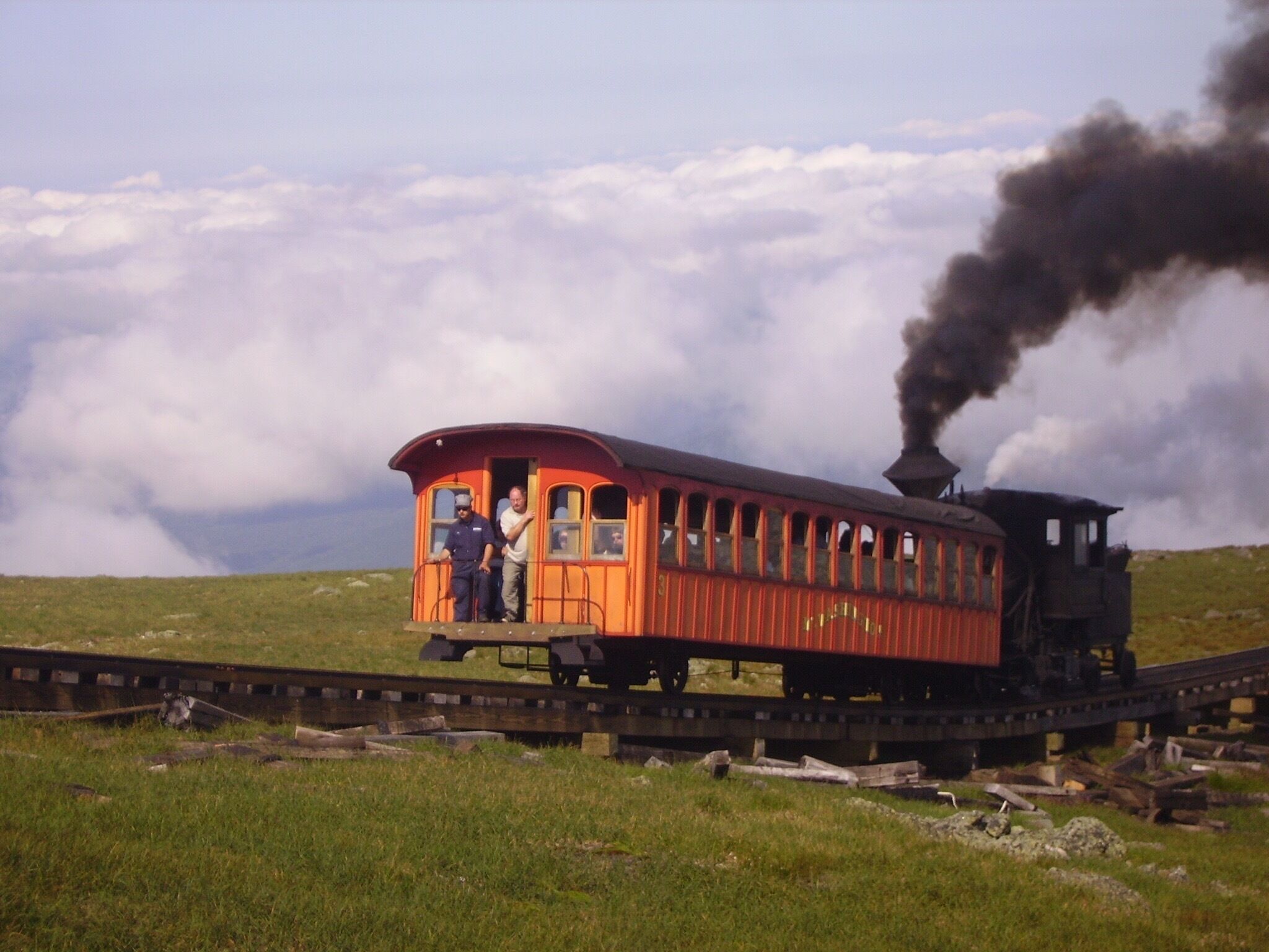 Cog Railway slowly creeping up Mount Washington.  Picture was taking from the Appalachian Trail just below the mountain's peak.